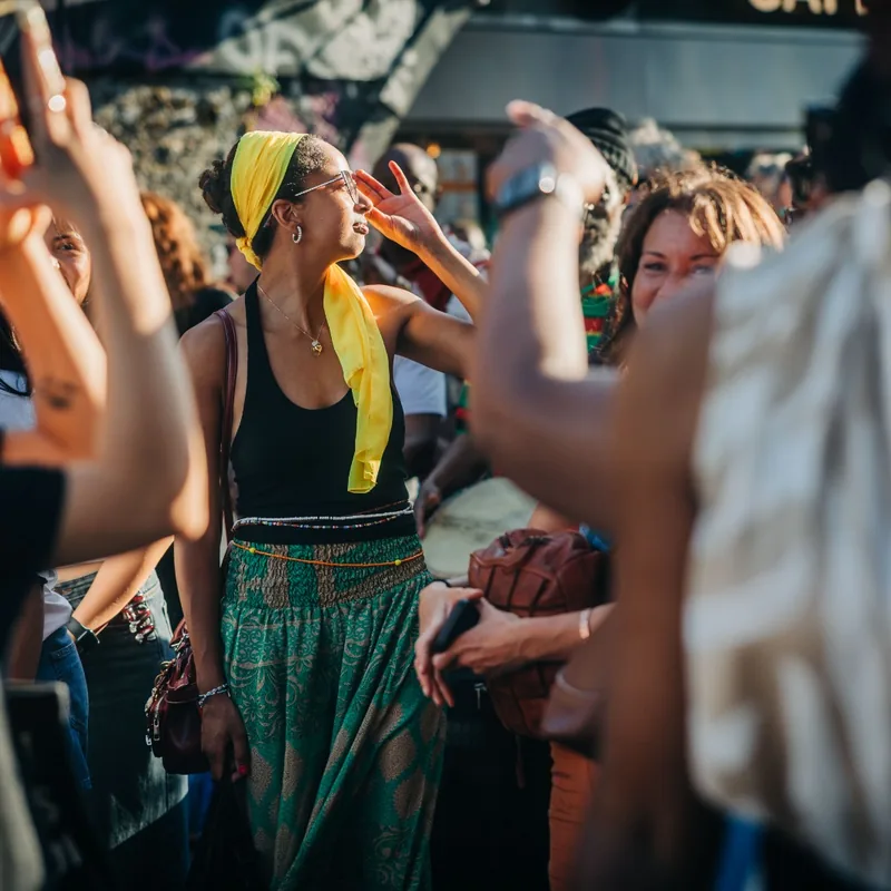 Women dancing with their hands raised at the rally.